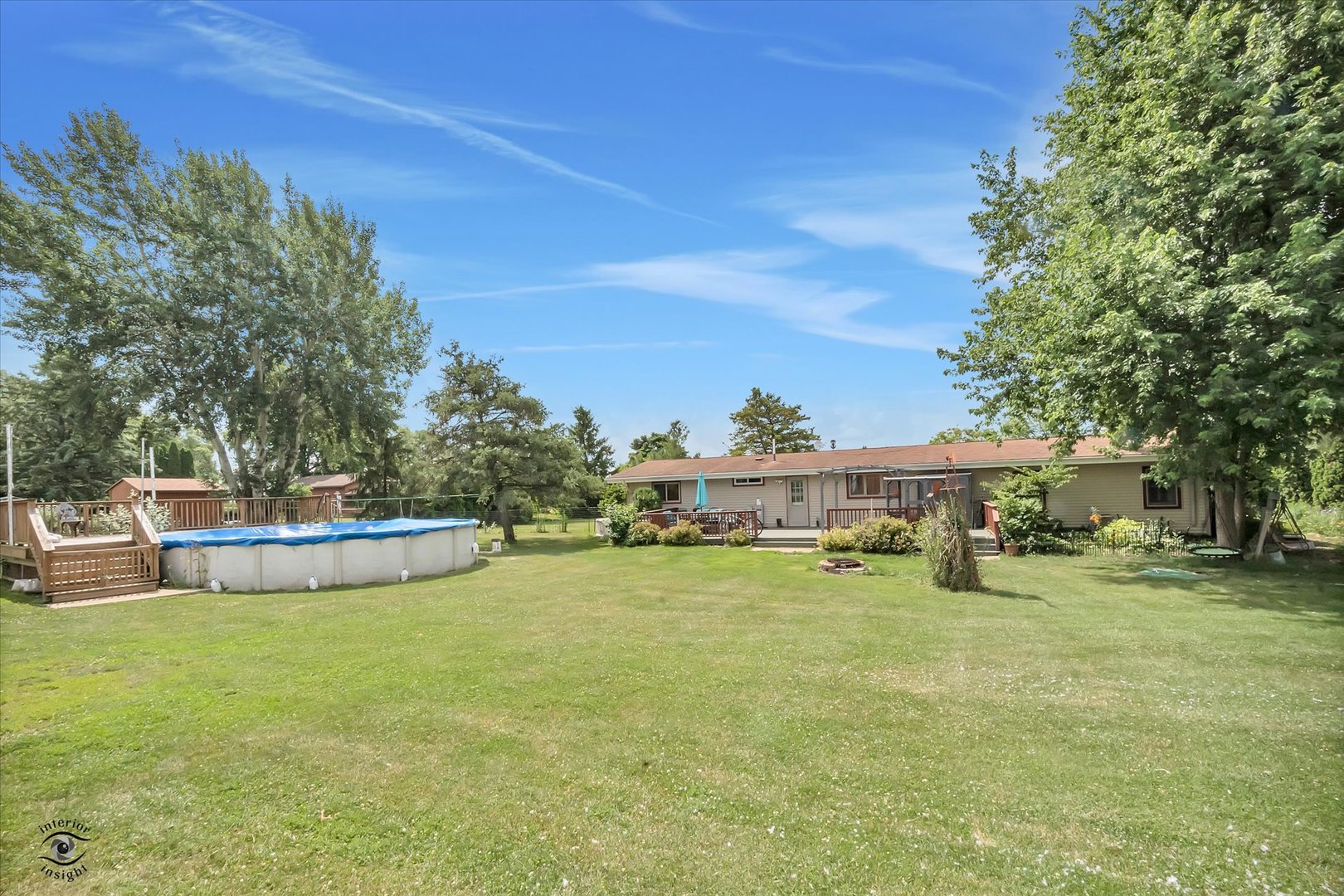 944 East County Line Road Grant Park, IL 60940 - Photo 41 of 46 a view of a swimming pool with lawn chairs and a big yard
