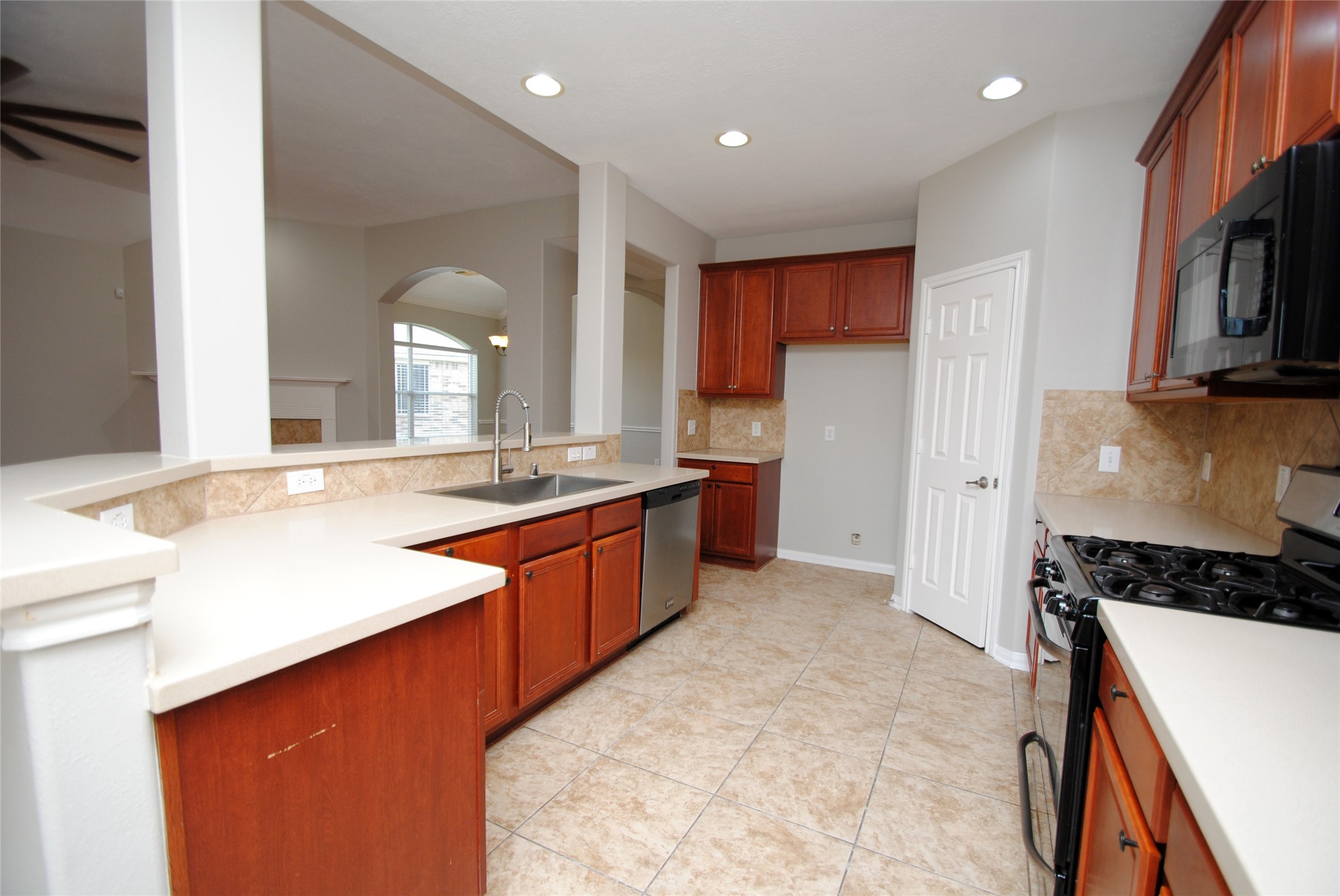 13409 Garden Spring Court Rosharon, TX 77583 - Photo 12 of 38 a kitchen with stainless steel appliances granite countertop a sink a stove and a refrigerator