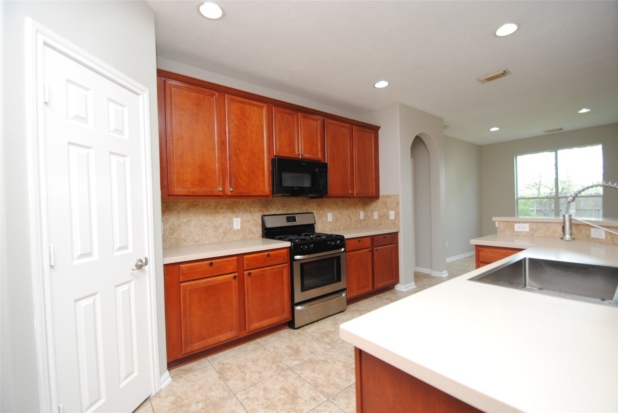 13409 Garden Spring Court Rosharon, TX 77583 - Photo 15 of 38 a kitchen with stainless steel appliances granite countertop a sink stove and refrigerator