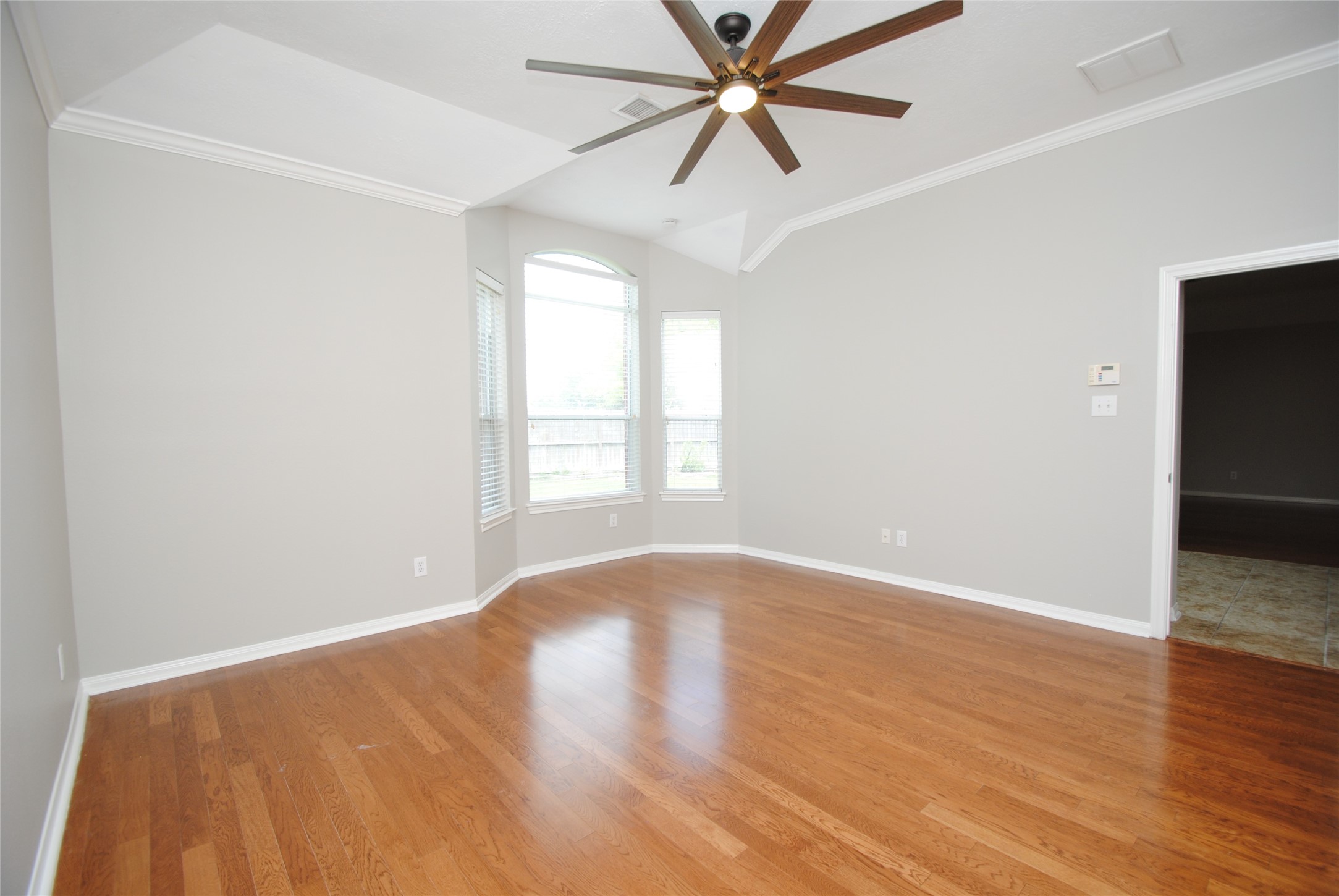 13409 Garden Spring Court Rosharon, TX 77583 - Photo 17 of 38 an empty room with wooden floor fan and windows
