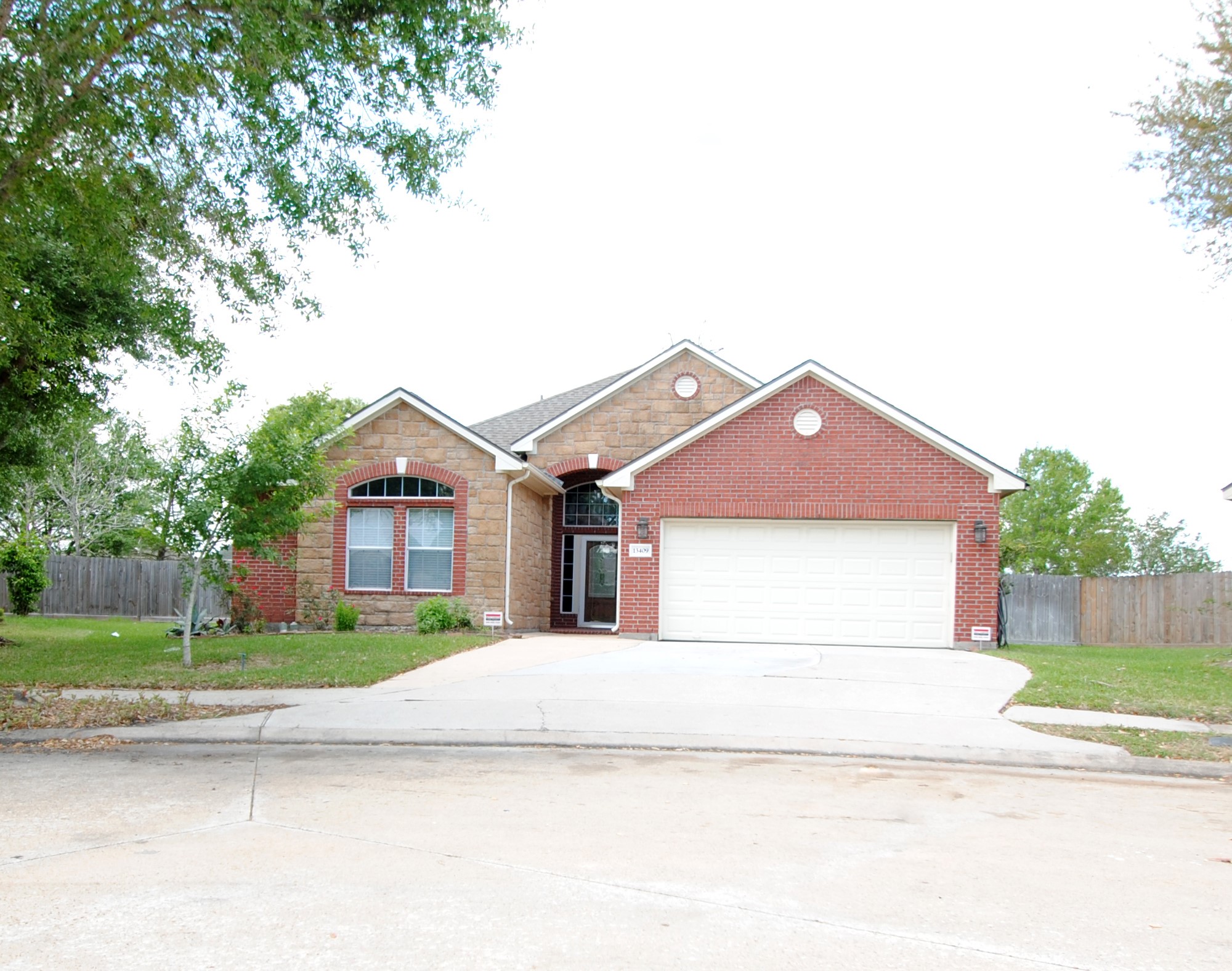 13409 Garden Spring Court Rosharon, TX 77583 - Photo 2 of 38 a front view of a house with a yard and garage