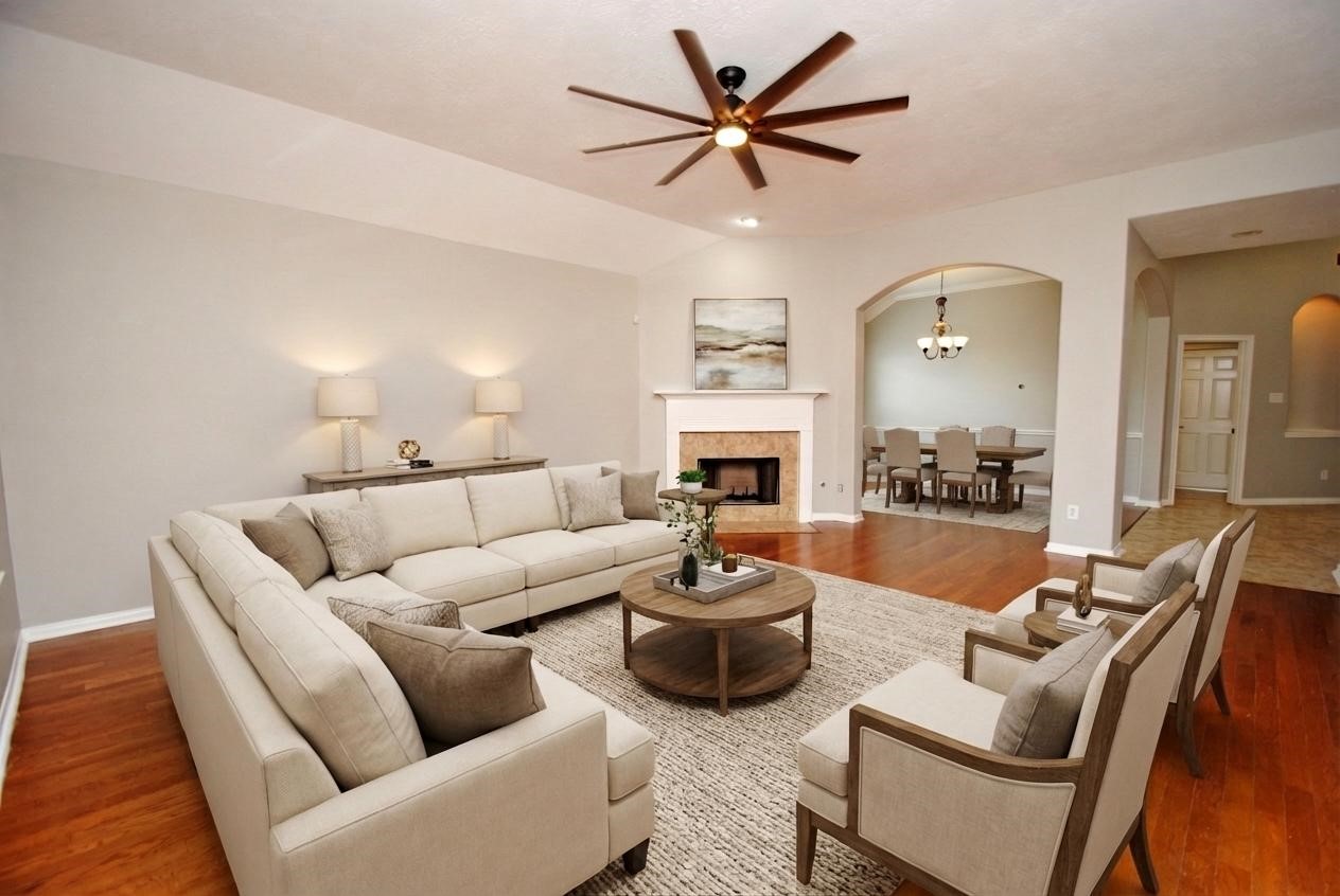 13409 Garden Spring Court Rosharon, TX 77583 - Photo 9 of 38 a living room with furniture a fireplace and a chandelier