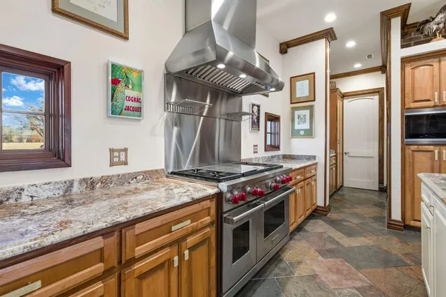 a kitchen with stainless steel appliances granite countertop a stove and a refrigerator