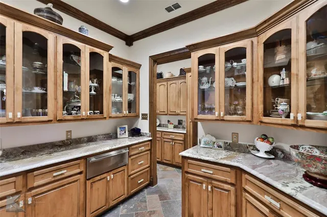 a kitchen with granite countertop a sink and cabinets