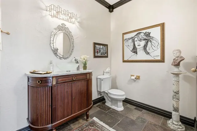 a bathroom with a toilet a sink and a mirror