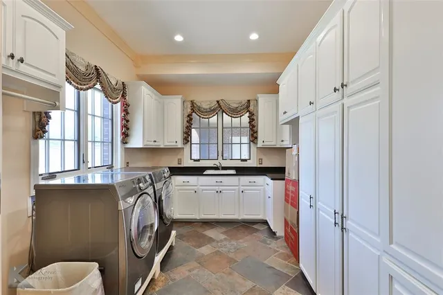 a kitchen with stainless steel appliances a stove a sink and a refrigerator