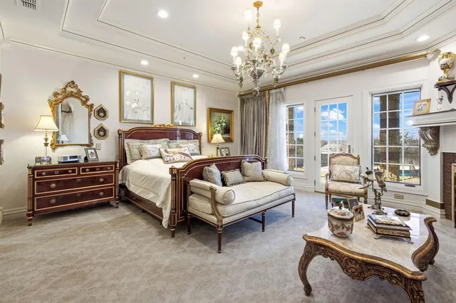 a bedroom with furniture and a chandelier