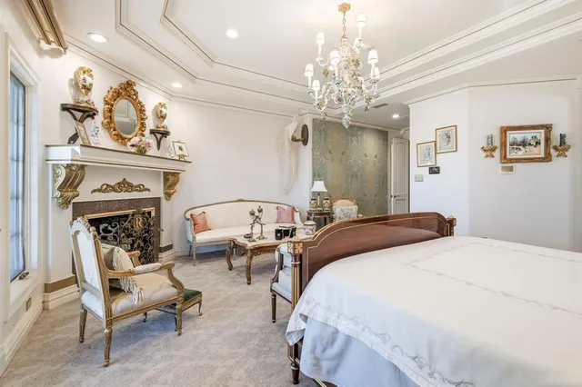 a spacious bedroom with a bed and a fireplace