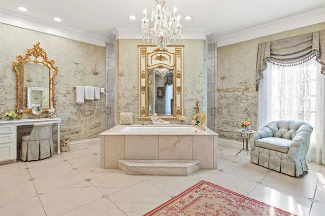 a large spacious bathroom with a double vanity sink a mirror a bathtub and next to a window