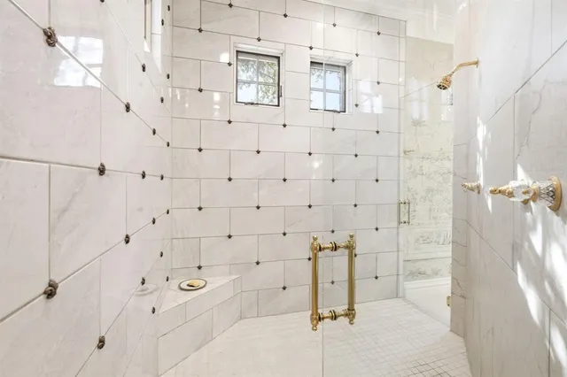 a bedroom with bed and a large window