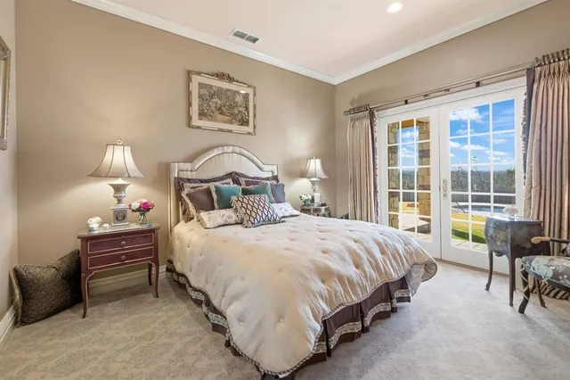 a bedroom with a bed and a dresser next to a window