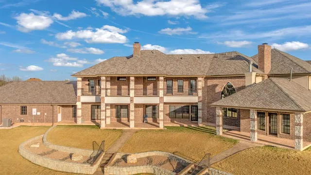 a view of a white house with a swimming pool and sitting area