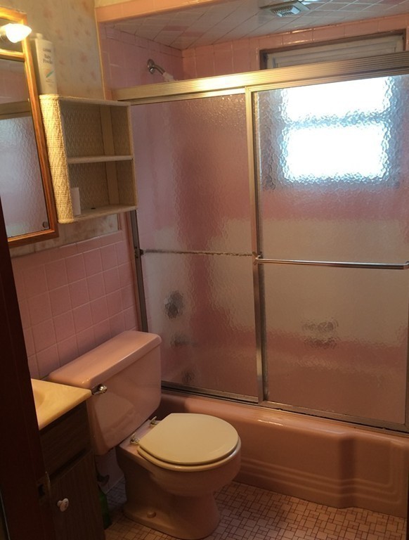 21 Beach Road Revere, MA 02151 - Photo 14 of 21 a white toilet sitting next to a window