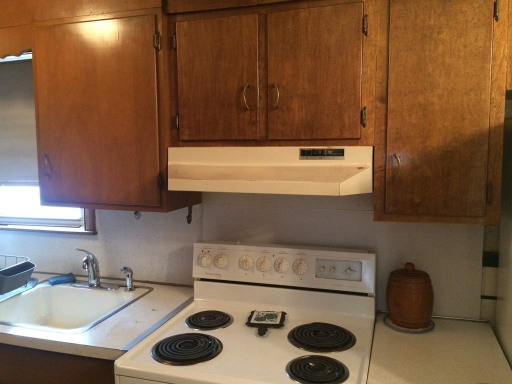 21 Beach Road Revere, MA 02151 - Photo 16 of 21 a kitchen with a sink a stove and cabinets