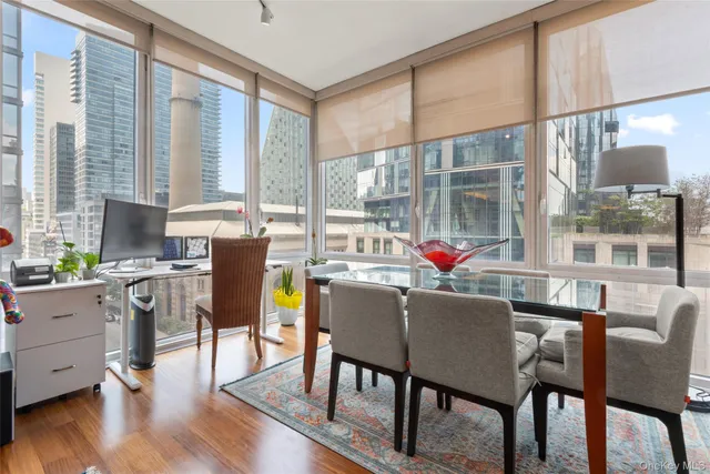 a dining room with furniture a chandelier and wooden floor