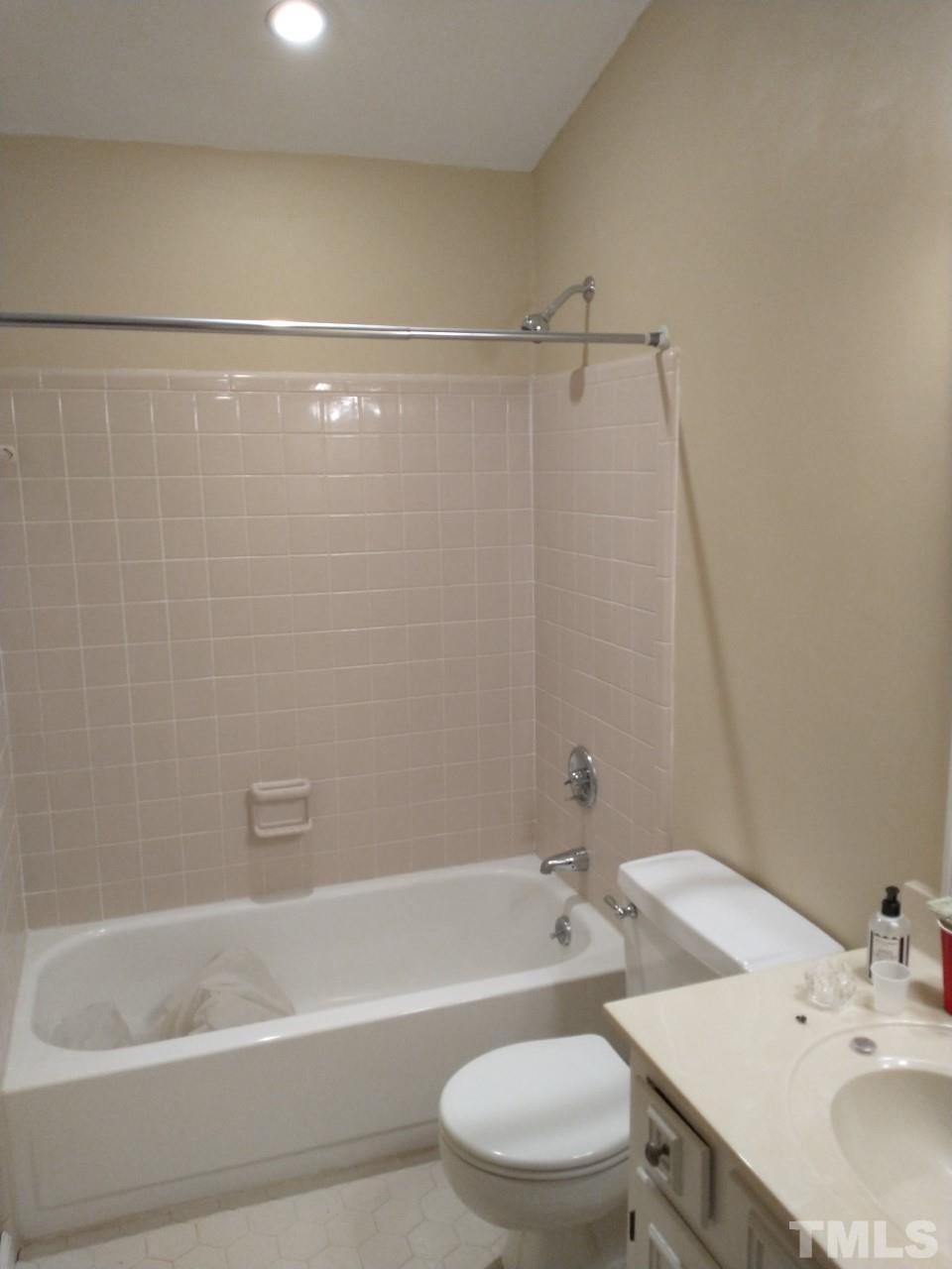 7300 Wilderness Road Raleigh, NC 27613 - Photo 12 of 15 a bathroom with a sink a toilet and a bathtub