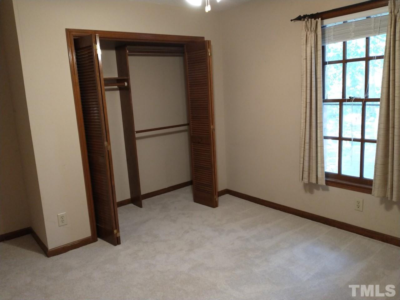 7300 Wilderness Road Raleigh, NC 27613 - Photo 13 of 15 an empty room with windows and closet