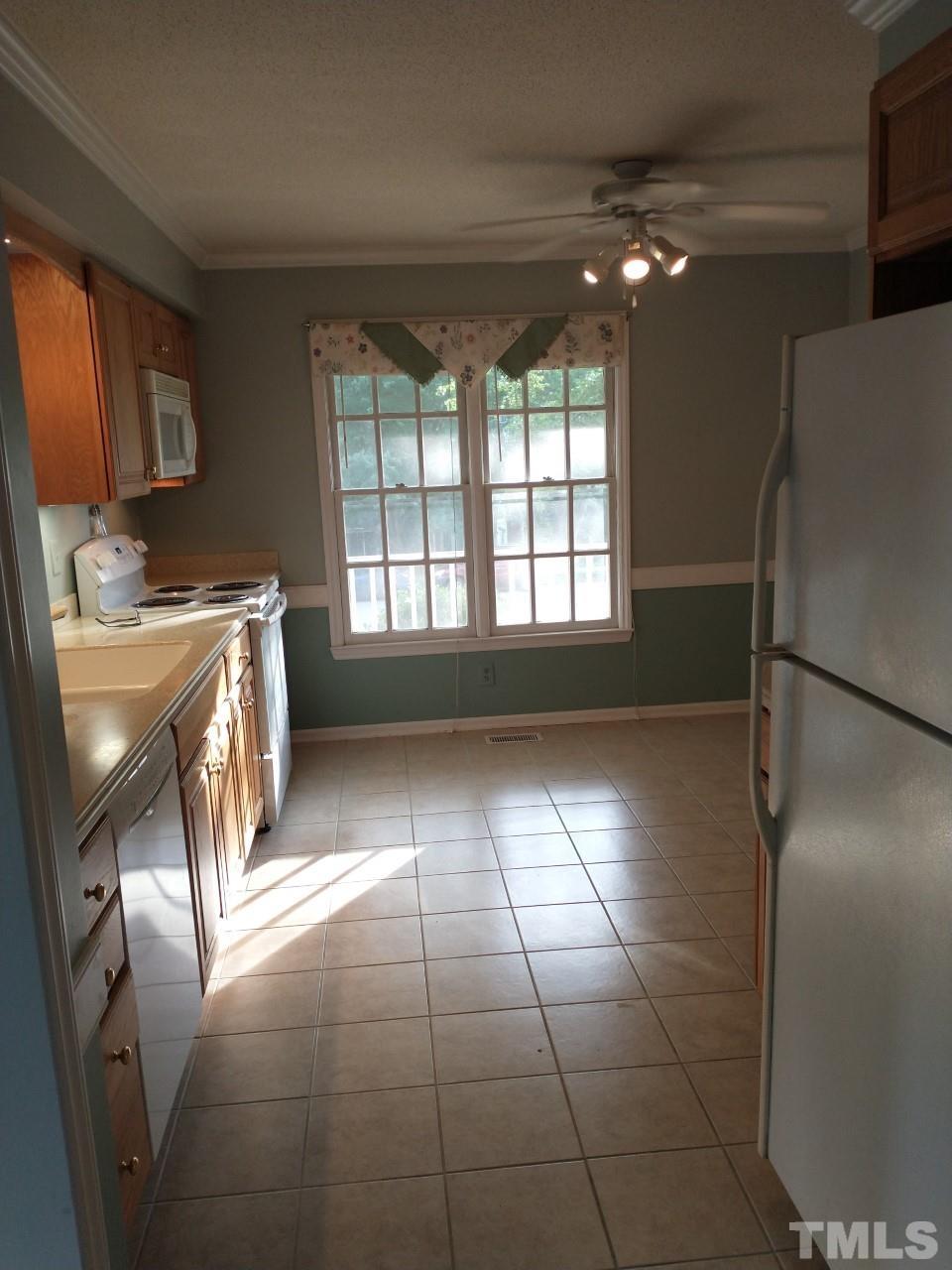 7300 Wilderness Road Raleigh, NC 27613 - Photo 3 of 15 a kitchen with stainless steel appliances granite countertop a refrigerator a stove a sink and dishwasher