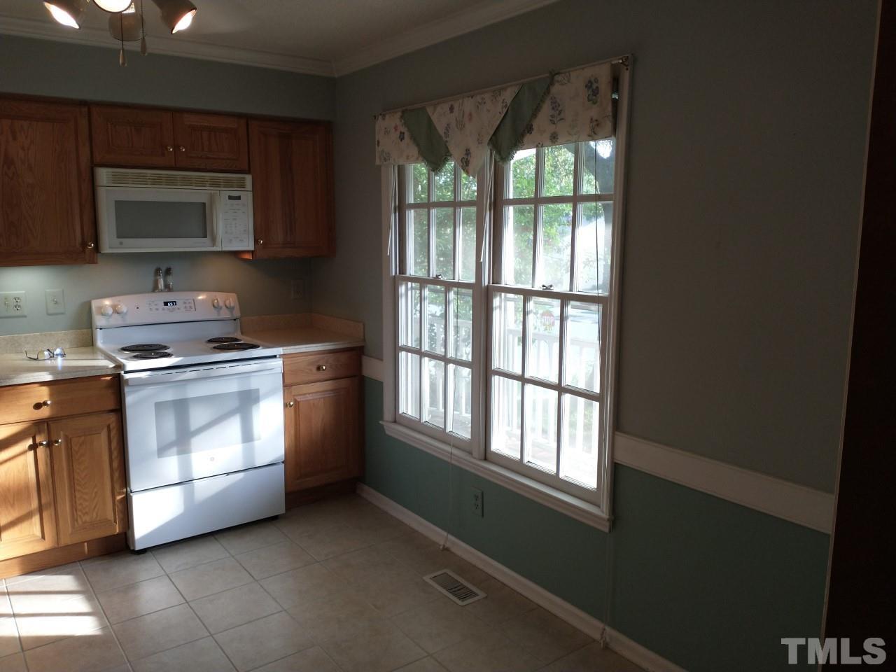 7300 Wilderness Road Raleigh, NC 27613 - Photo 4 of 15 a kitchen with a stove microwave and sink