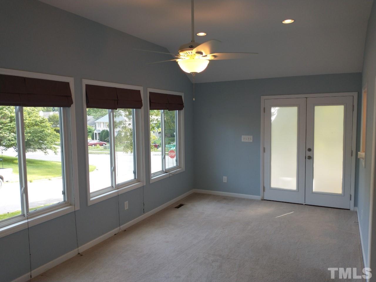 7300 Wilderness Road Raleigh, NC 27613 - Photo 6 of 15 a view of an empty room with a window and a kitchen