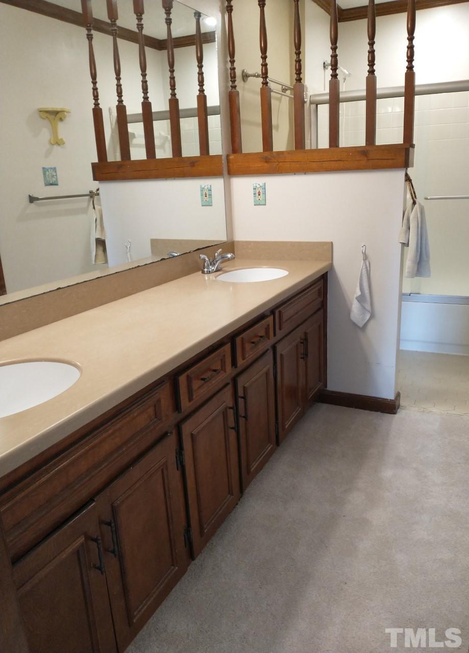 7300 Wilderness Road Raleigh, NC 27613 - Photo 8 of 15 a bathroom with a sink and a mirror