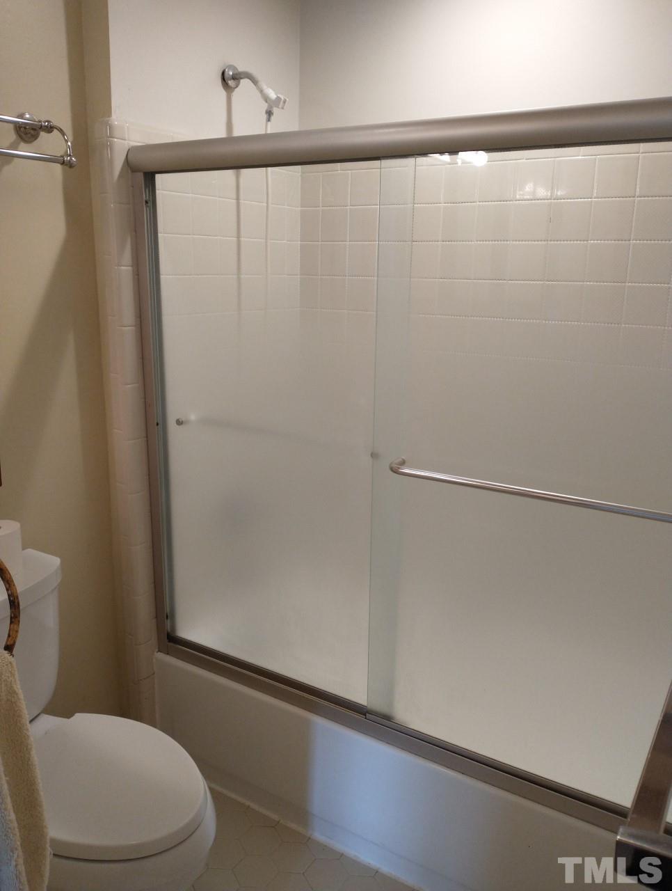 7300 Wilderness Road Raleigh, NC 27613 - Photo 9 of 15 a white toilet sitting next to a shower