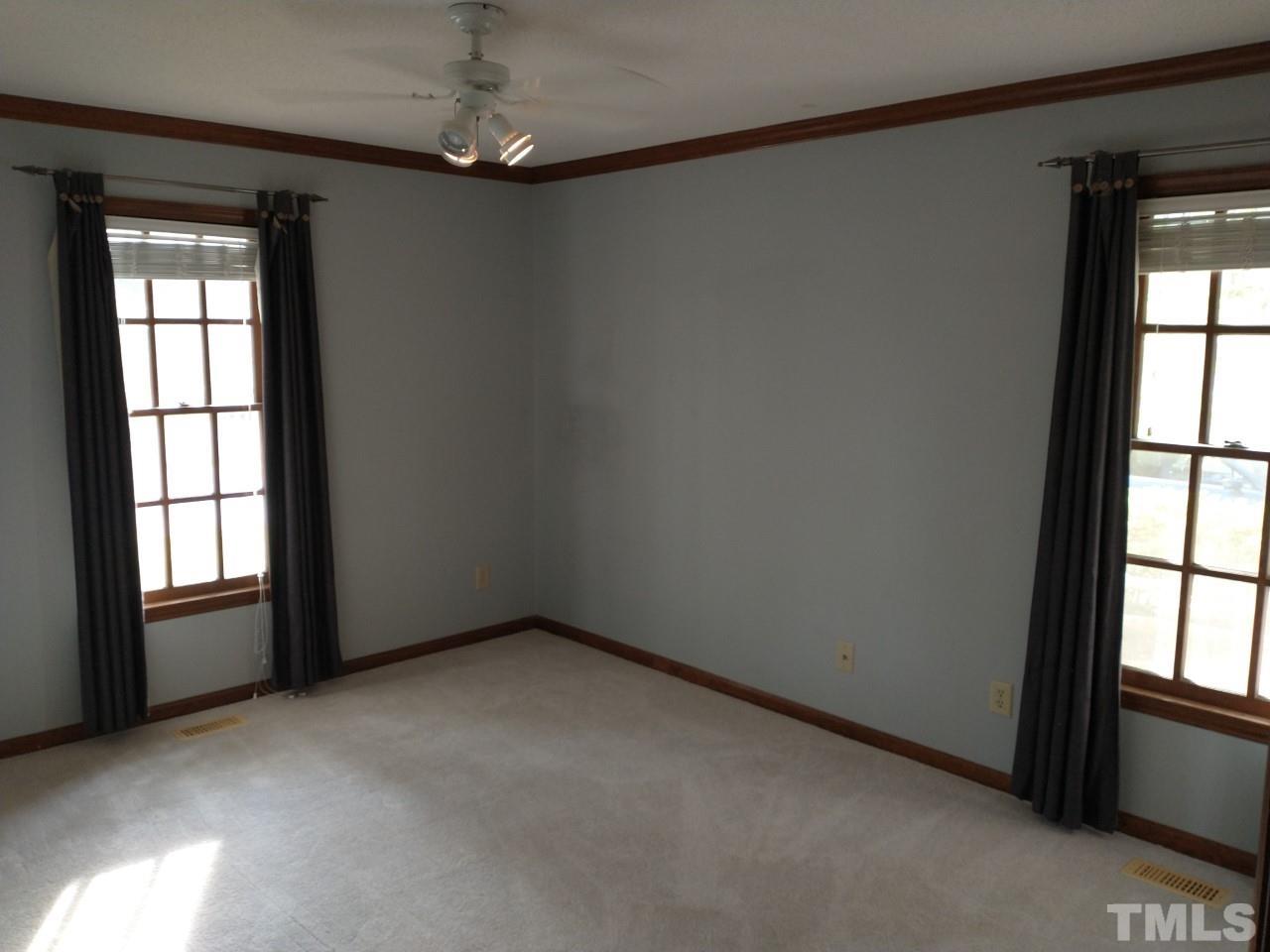 7300 Wilderness Road Raleigh, NC 27613 - Photo 10 of 15 an empty room with windows and closet