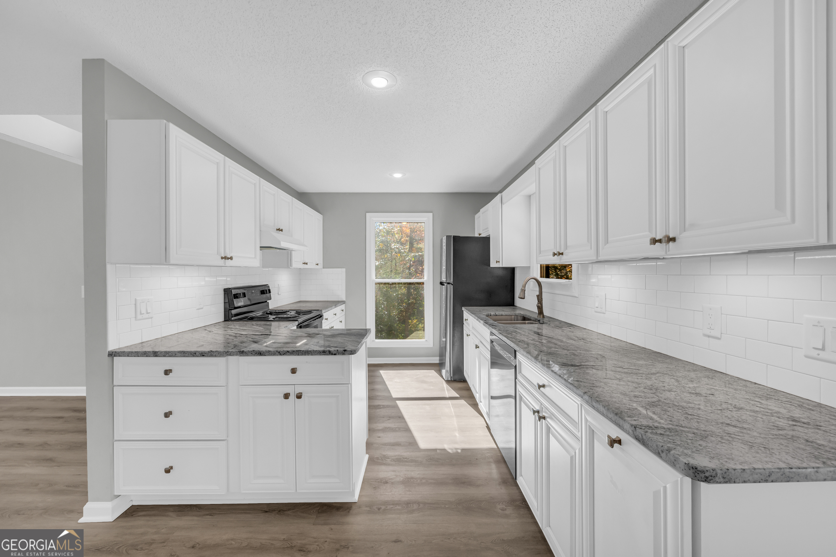 222 Blue Ridge Drive Sautee Nacoochee, GA 30571 - Photo 11 of 106 a kitchen with granite countertop a sink a counter top space stainless steel appliances and cabinets