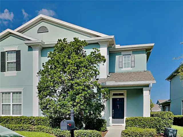 a front view of a house with plants