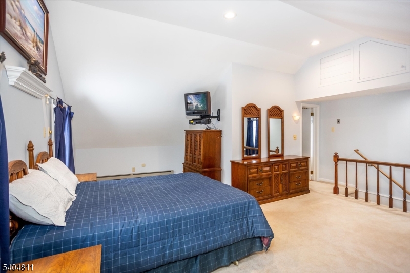 100 Troy Hills Road Whippany, NJ 07981 - Photo 22 of 37 a bedroom with a bed and dresser with mirror