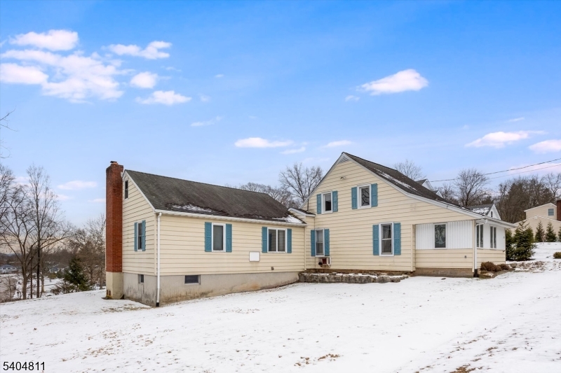 100 Troy Hills Road Whippany, NJ 07981 - Photo 3 of 37 a view of a white house with a yard covered in snow