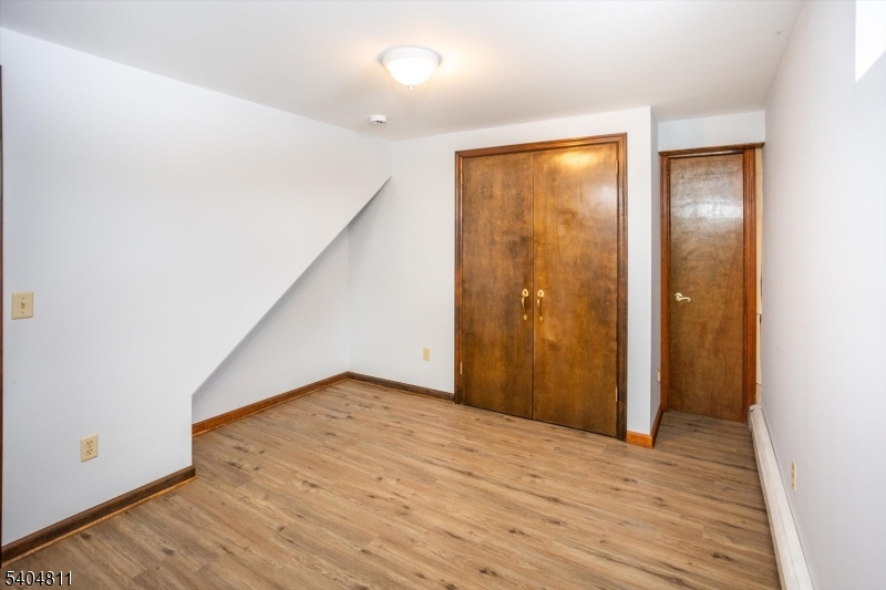 100 Troy Hills Road Whippany, NJ 07981 - Photo 31 of 37 a view of an empty room with wooden floor and closet