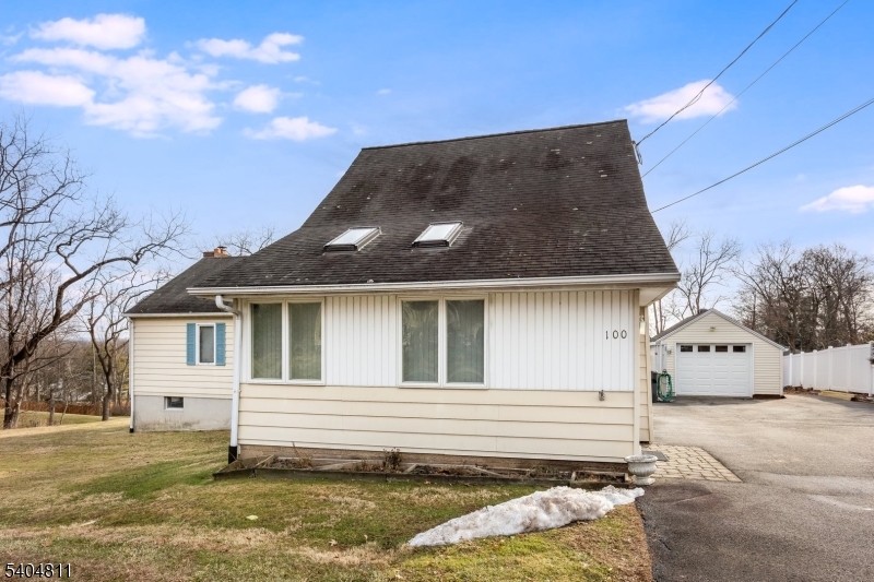 100 Troy Hills Road Whippany, NJ 07981 - Photo 4 of 37 a view of a white house with a yard and garage