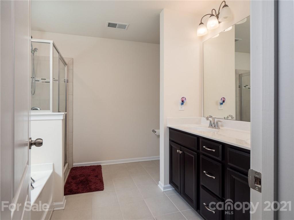 79157 Ridgehaven Road, Unit 154 Lancaster, SC 29720 - Photo 14 of 23 a bathroom with a double vanity sink and mirror