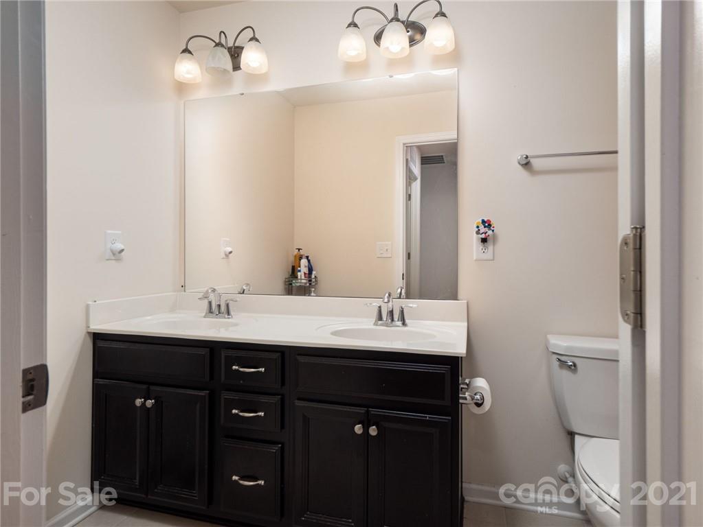 79157 Ridgehaven Road, Unit 154 Lancaster, SC 29720 - Photo 17 of 23 a bathroom with a double vanity sink and mirror