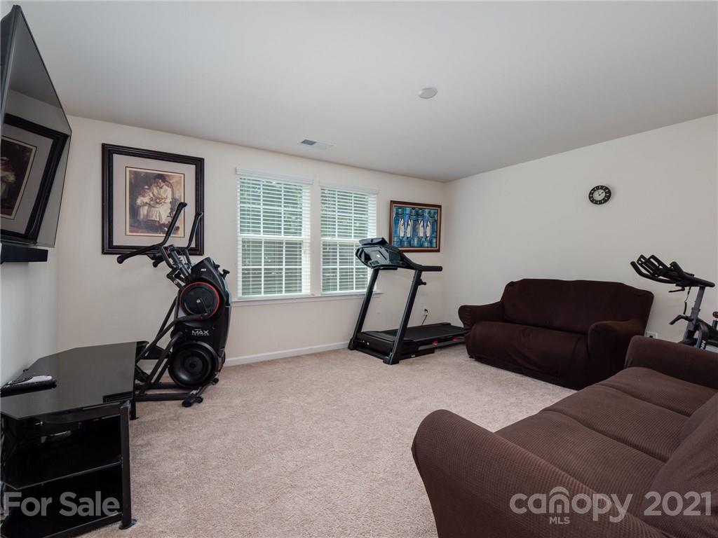79157 Ridgehaven Road, Unit 154 Lancaster, SC 29720 - Photo 20 of 23 a living room with furniture gym equipment and a large window