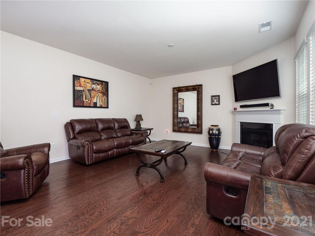 79157 Ridgehaven Road, Unit 154 Lancaster, SC 29720 - Photo 7 of 23 a living room with furniture a fireplace and a flat screen tv