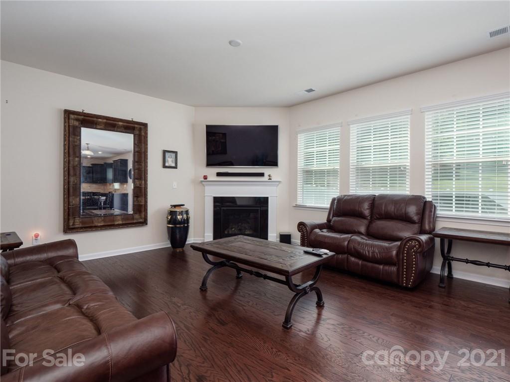 79157 Ridgehaven Road, Unit 154 Lancaster, SC 29720 - Photo 8 of 23 a living room with furniture a flat screen tv and a fireplace