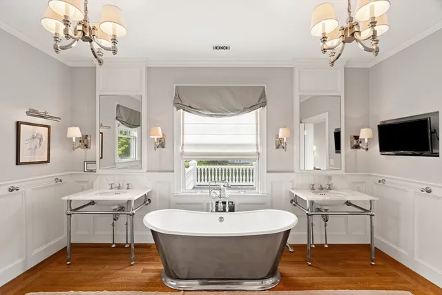a spacious bathroom with a sink a large mirror and a bathtub