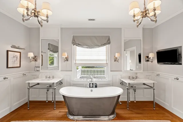 a spacious bathroom with a sink a large mirror and a bathtub