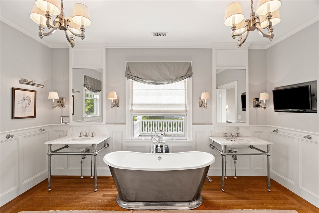 4 Cobb Avenue Manchester, MA 01944 - Photo 21 of 41 a spacious bathroom with a sink a chandelier and a flat screen tv