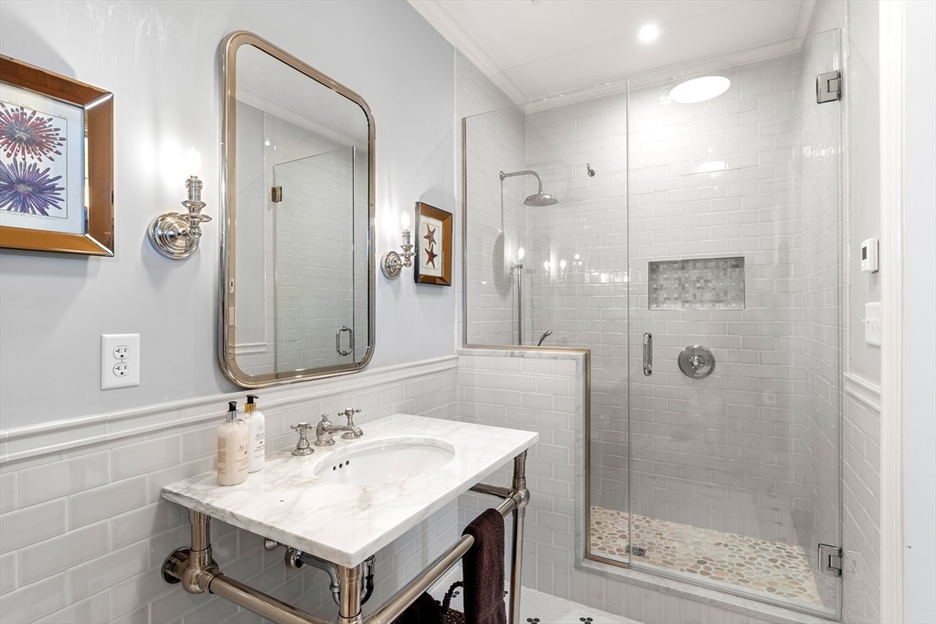 4 Cobb Avenue Manchester, MA 01944 - Photo 24 of 41 a bathroom with a sink and a mirror