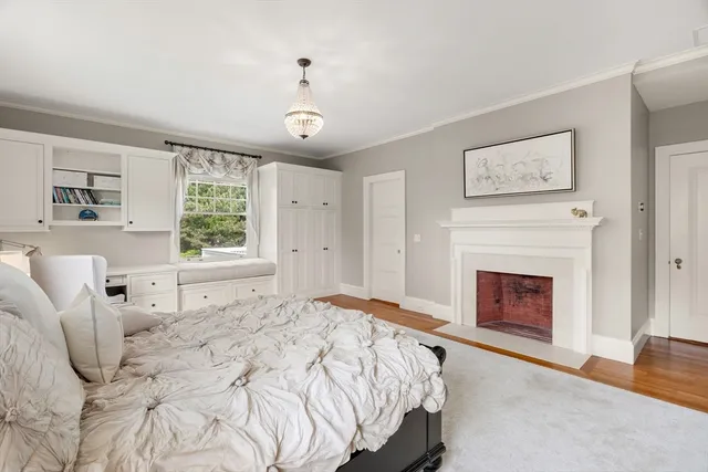 a bedroom with a bed and a fireplace