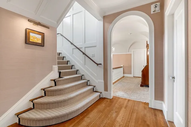 a view of entryway and hall with wooden floor