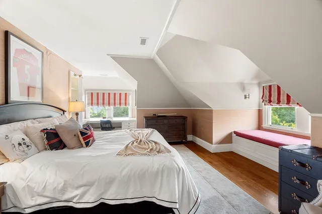 a bedroom with a bed and a dresser in it