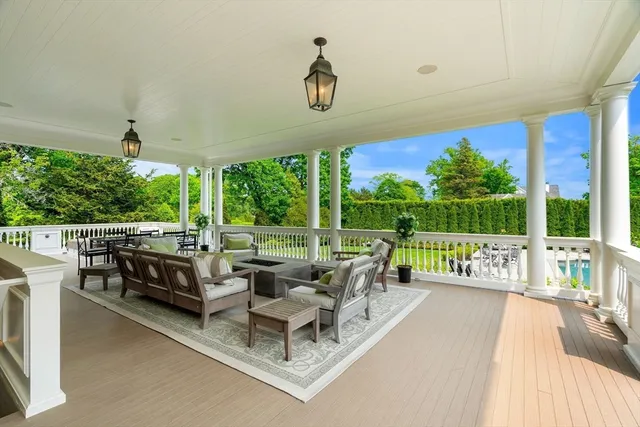 a living room with large windows and a table