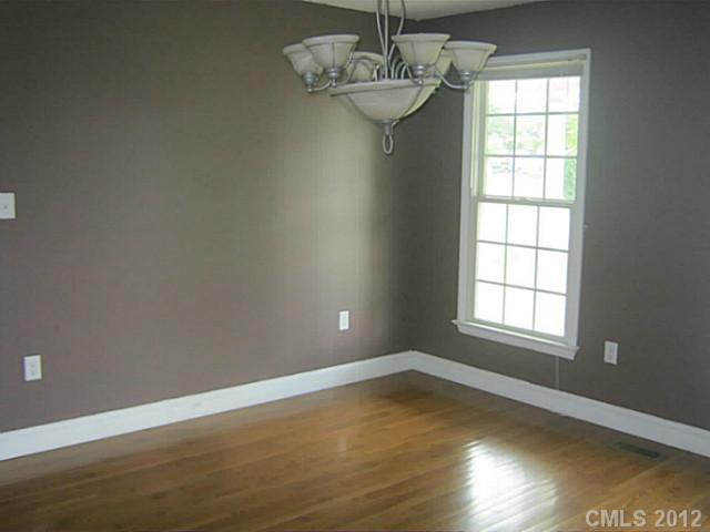 147 Laren Road Shelby, NC 28152 - Photo 5 of 16 an empty room with wooden floor and windows