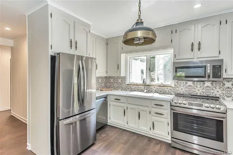 a kitchen with stainless steel appliances granite countertop a stove and a refrigerator