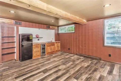 a view of a kitchen with refrigerator and window