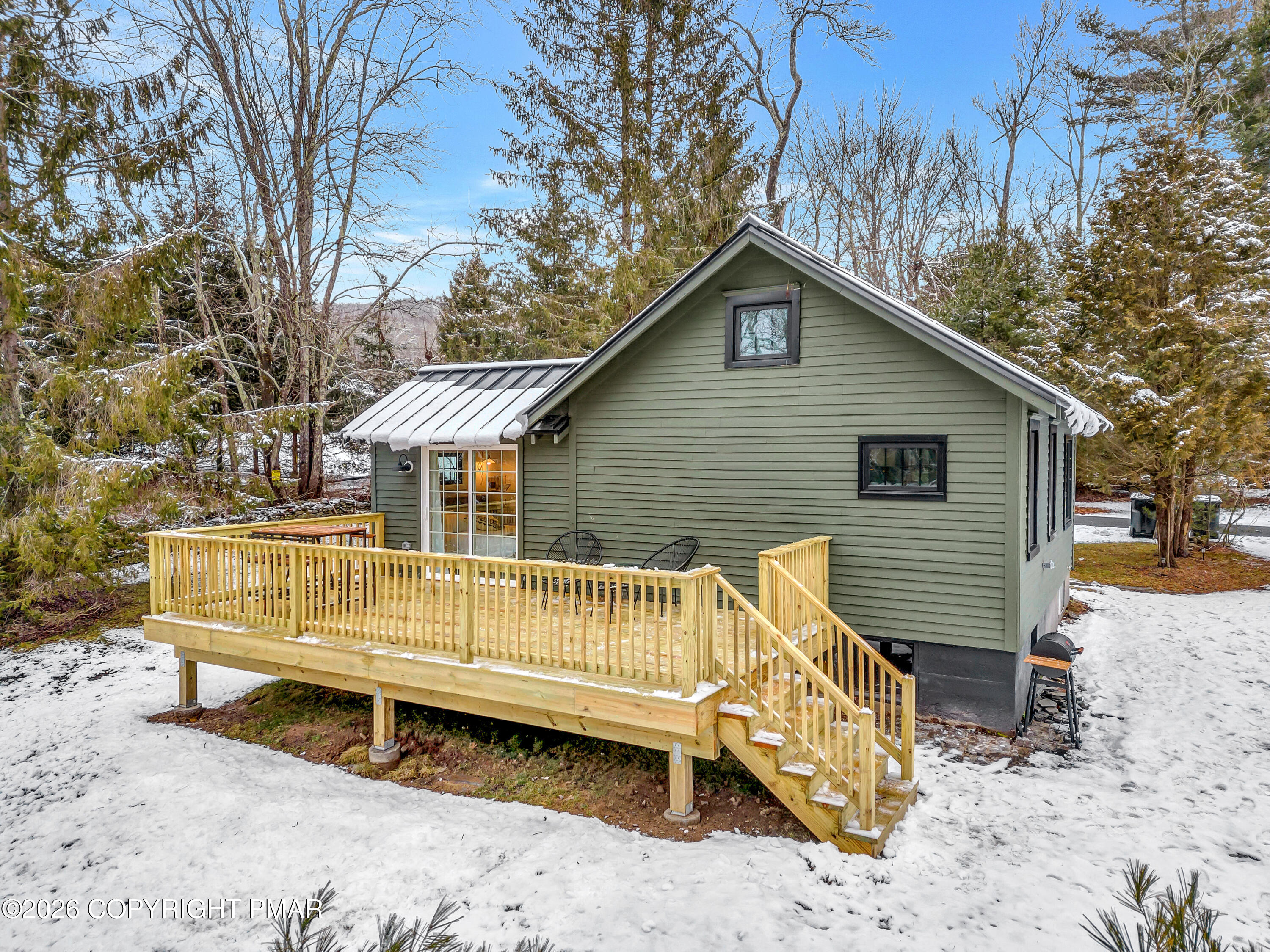 353 German Hill Road Shohola, PA 18458 - Photo 32 of 35 a view of a wooden house with a wooden bench in a backyard